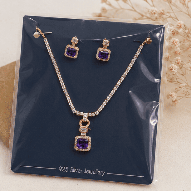 rose gold necklace set with purple crystal pendant and matching earrings