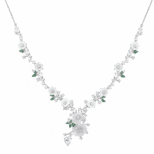Alt Text:
Front view of a 925 sterling silver floral blossom necklace with white flowers, green enamel leaves, sparkling cubic zirconia, and adjustable slider chain on a white background.