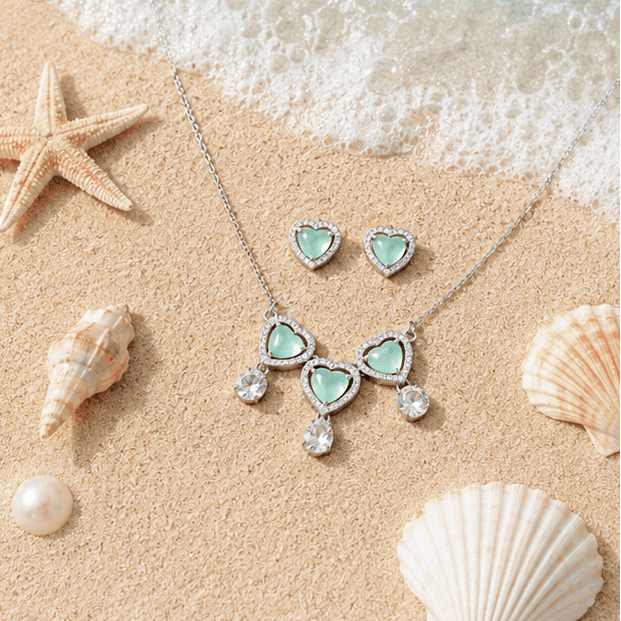 Close-up view of the Ocea Heart 925 sterling silver necklace featuring sparkling zircon accents and mint green heart stones.