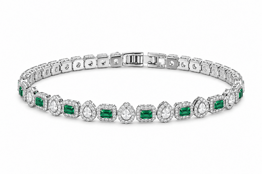 Diamond bracelet with emerald stones on a white background