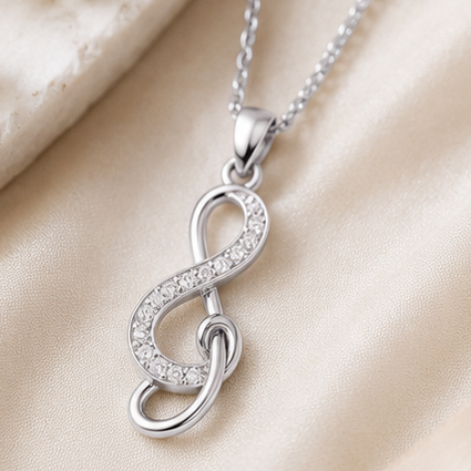Silver necklace with a unique pendant displayed in various settings.