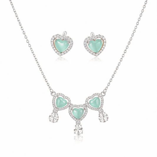 Vrindae Argente Ocea Heart 925 sterling silver necklace set with matching mint green heart earrings on white background.