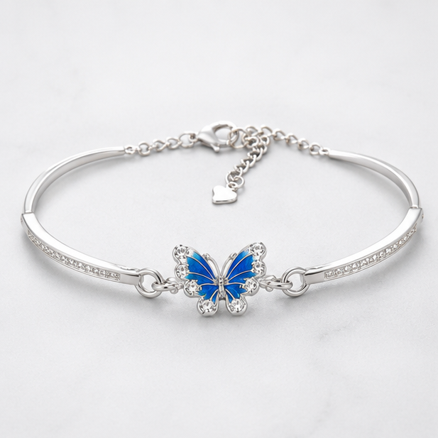 Vrindae Argente Azure Flutter 92.5 sterling silver butterfly kada bracelet with blue enamel butterfly on a plain white background.