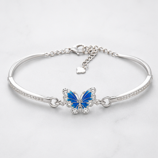Vrindae Argente Azure Flutter 92.5 sterling silver butterfly kada bracelet with blue enamel butterfly on a plain white background.