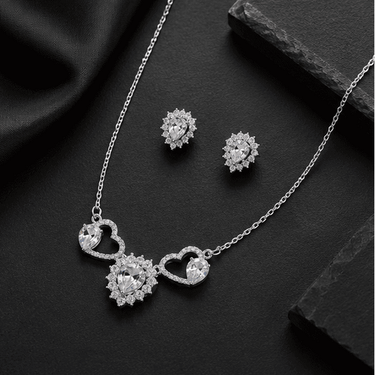 925 silver necklace set showcasing sparkling heart motifs and matching earrings.