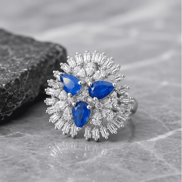 Close-up of the sapphire-blue floral sterling silver ring showcasing sparkling zircon detailing and premium craftsmanship.