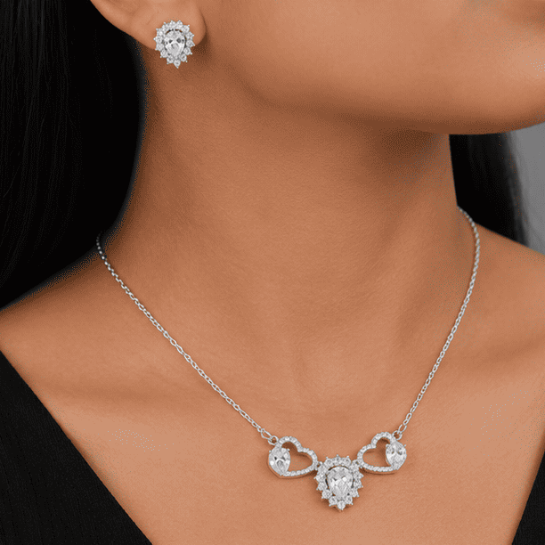 Model wearing the Vrindae Argente Celestia Twin Hearts 925 sterling silver necklace with matching crystal stud earrings.