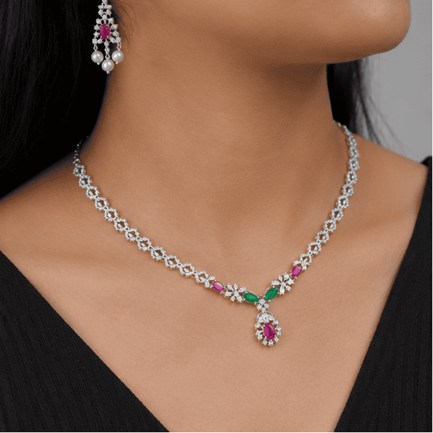 Close-up view highlighting the sparkling cubic zirconia, ruby and emerald stones, pearl drop earrings, and intricate craftsmanship of the 925 sterling silver necklace set